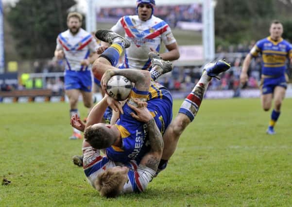 Zak Hardaker's run is stopped close to the line by Tom Johnstone.  Picture: Bruce Rollinson