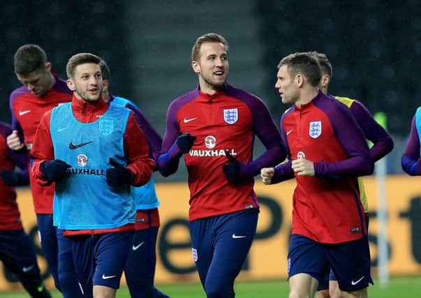 Captains run:James Milner, right, is joined by Harry Kane, centre, and Adam Lallana in a pre-match training session