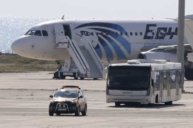 A bus carries some passengers from the hijacked EgyptAir aircraft as at it landed at Larnaca airport