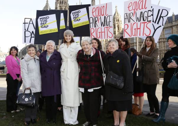 Actress Gemma Arterton (centre) with some original Dagenham women strikers outside Parliament. (PA Wire).