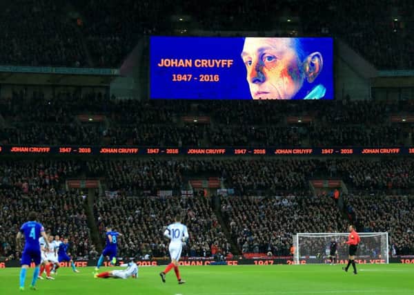 A tribute to Netherlands legend Johan Cruyff is shown on the giant screen throughout the 14th minute at Wembley on Tuesday night. Picture: Mike Egerton/PA.