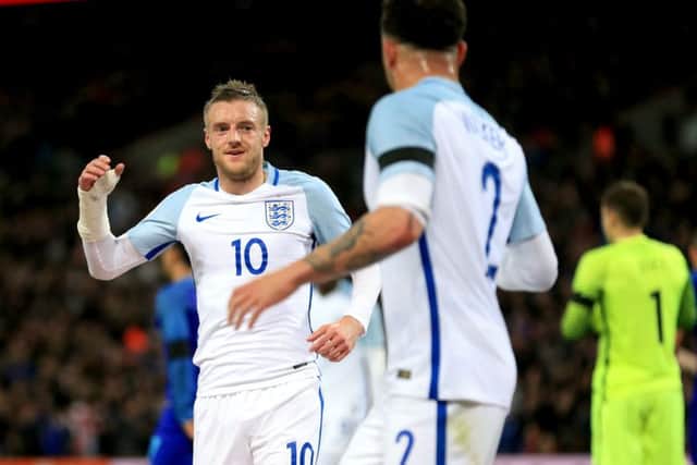 England's Jamie Vardy (left) celebrates scoring his side's first goal of the game with teammate Kyle Walker (right)