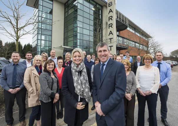 NEW PREMISES: Elizabeth Ridler, of Knight Frank, and Ian Ruthven, of Barratt Homes, with Barratt staff, outside Raynham House at Capitol Park.