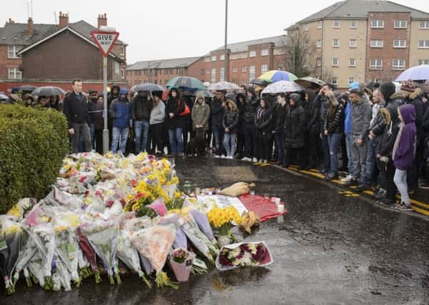 People gather for a memorial on the street as a second vigil has been held for the well-respected Muslim shopkeeper who was killed in what police are treating as a "religiously prejudiced" attack.