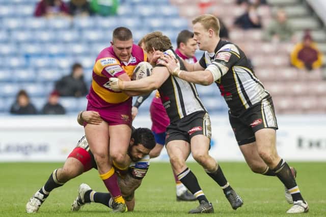 TOUGH START: Huddersfield Giants' Josh Johnson is grabbed by Salford's Ben Murdoch-Masila, (left) and (centre) Logan Tomkins in the home side's Easter Monday defeat. Picture: James Hardisty.