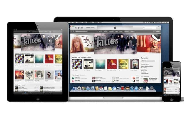 An iPad, Macbook and iPhone displaying iTunes