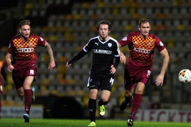 Gary Liddle, left, Ben Pearson and James Hanson chase the ball. during the Yorkshire derby between Bradford City and Barnsley in the second round in October.  Picture: Bruce Rollinson