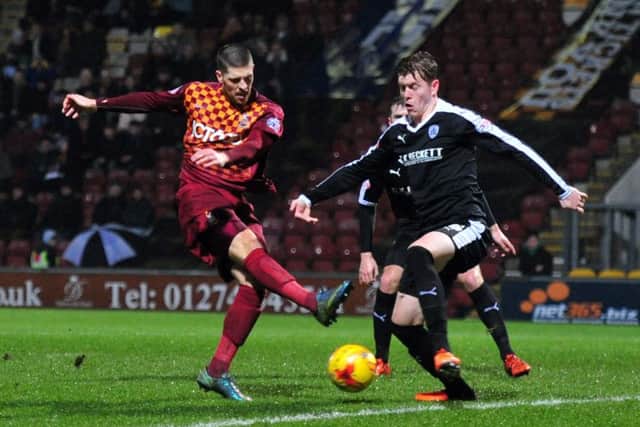 Barnsley's Alfie Mawson battles with Bradford's Jamie Proctor. Picture by Tony Johnson.
