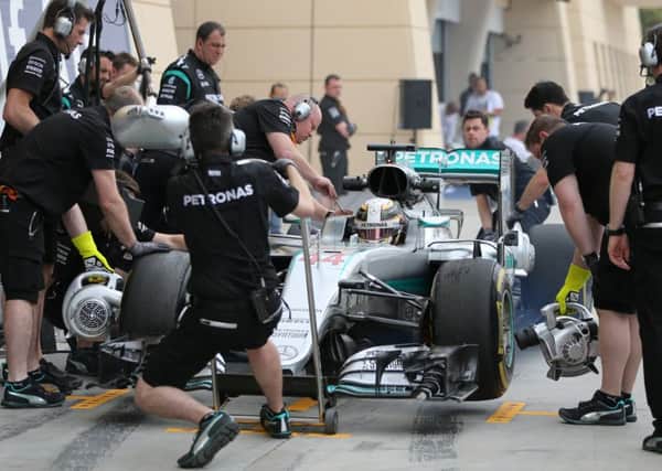 Mechanics work on the car of Mercedes driver Lewis Hamilton.
