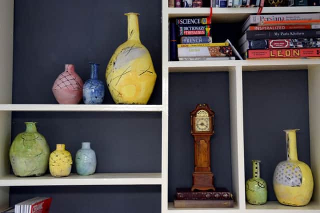 These shelves hold all kinds of treasures, including Emily's pots and a grandfather clock handcrafted by her grandad