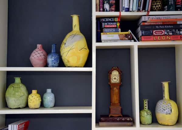 These shelves hold all kinds of treasures, including Emily's pots and a grandfather clock handcrafted by her grandad