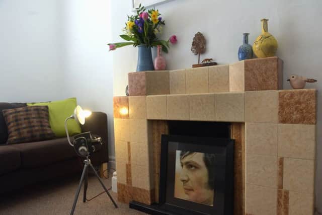 The sitting room with lamp by David Howie, Emily's ceramics on the mantlepiece and a picture of Rolling Stones drummer, Charlie Watts in the fireplace