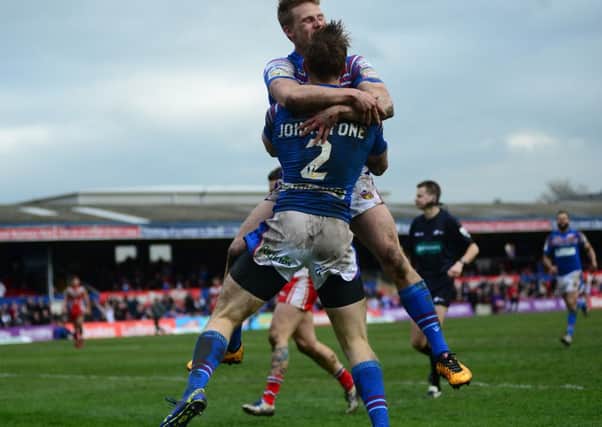 Tom Johnstone celebrates his second try with team mate Jacob Miller. Picture Scott Merrylees