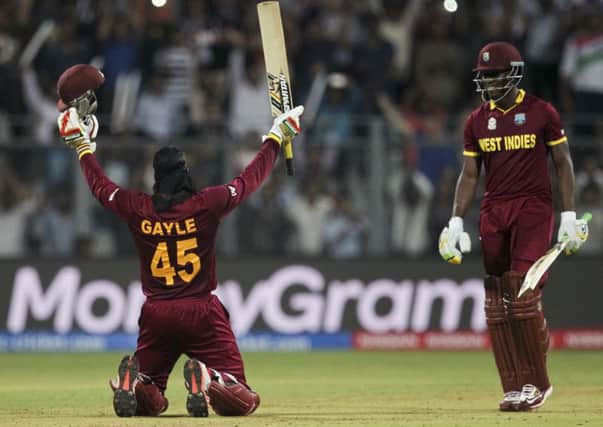 West Indies Chris Gayle raises his bat after scoring hundred runs against England during the group phase. Picture: AP /Rafiq Maqbool