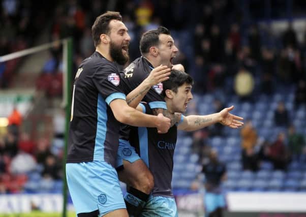 Sheffield Wednesday's Fernando Forestieri, right, celebrates with Atdhe Nuhiu, left, and Ross Wallace after his goal beat Huddersfield Town (Picture: Steve Ellis).
