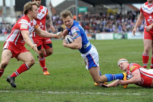 Wakefield Trinity Wildcats' Jacob Miller breaks clear of Salford's Carl Foster to score the opening try. 
Picture: Jonathan Gawthorpe