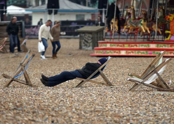 People enjoying the Spring conditions on Brighton beach.  Pic: Steve Parsons/PA Wire