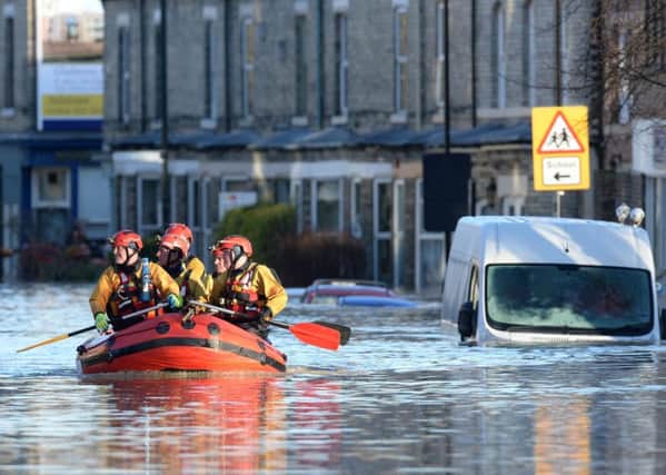 Members of a Mountain Rescue team paddle along Huntington Road in York, after the River Foss and Ouse burst their banks. Picture: Anna Gowthorpe/PA Wire