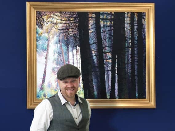 Artist Alister Colley with his highly-prized painting Forest Landscape - Swinsty.