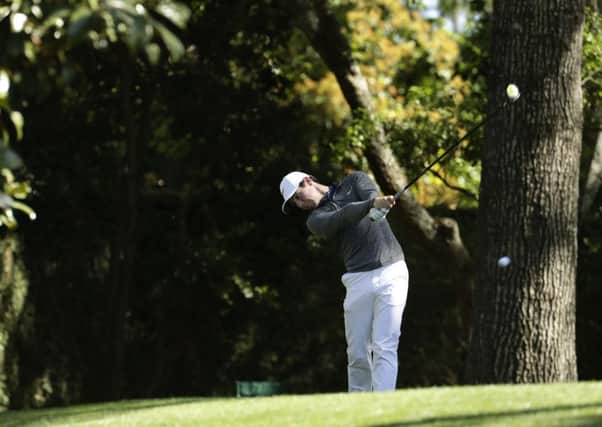 Rory McIlroy tees off on the second hole on Monday during a practice round for the Masters (Picture: Charlie Riedel/AP).