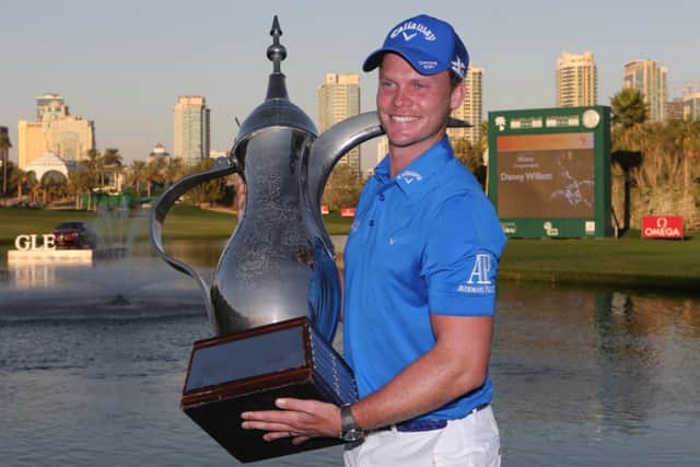 Sheffield's Danny Willett s with the trophy after he won the Dubai Desert Classic golf tournament in Dubai in February. (AP Photo/Kamran Jebreili)
