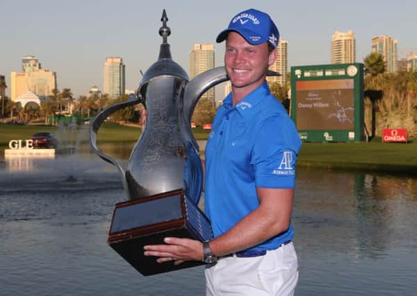 Sheffield's Danny Willett s with the trophy after he won the Dubai Desert Classic golf tournament in Dubai in February. (AP Photo/Kamran Jebreili)