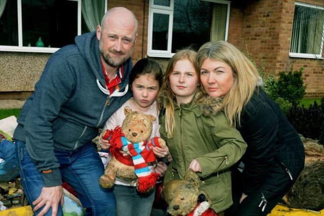 The Robinson family - Andy, Libby, six, Amy, nine, and Michelle outside their home.