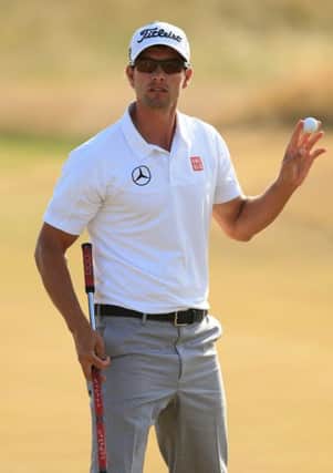 Australia's Adam Scott acknowledges the crowd after his putt during day three of the 2013 Open Championship at Muirfield Golf Club, East Lothian. PRESS ASSOCIATION Photo. Picture date: Saturday July 20, 2013. See PA story GOLF Open. Photo credit should read: Mike Egerton/PA Wire. RESTRICTIONS: Use subject to restrictions. Editorial use only. No commercial use. The Open Championship logo and prominent link to The Open website (www.TheOpen.com) to be included with published material. Call 44 (0)1158 447447 for further information.