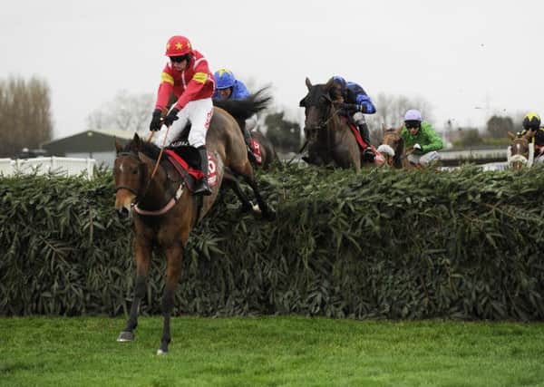 Highland Lodge and Henry Brooke jump the final fence as they win the Betfred Becher Chase in December last year but they are unlikely to feature in this years Grand National (Picture: John Giles/PA).