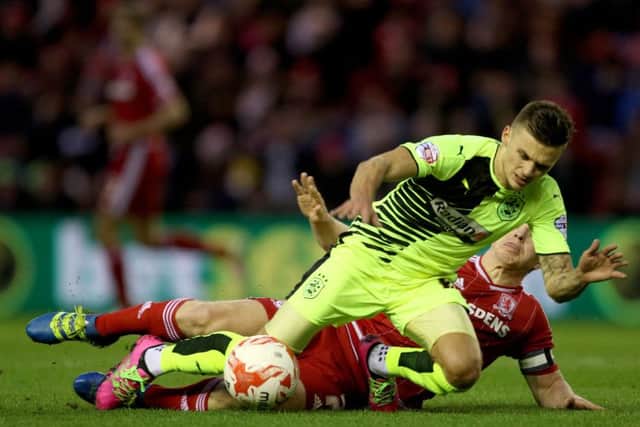 Huddersfield Town's Jamie Paterson is tackled by Middlesbrough's Grant Leadbitter during the Sky Bet Championship match at the Riverside. Picture: PA.