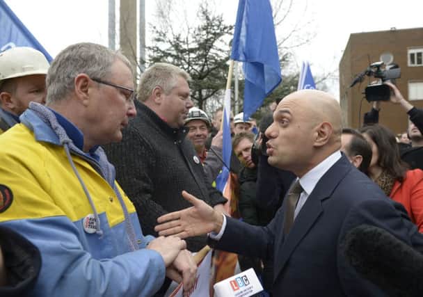Business Secretary Sajid Javid talks to workers as he leaves Tata Steel in Port Talbot, South Wales, as the Government outlined its response to the crisis gripping the steel industry. Photo: Ben Birchall/PA Wire