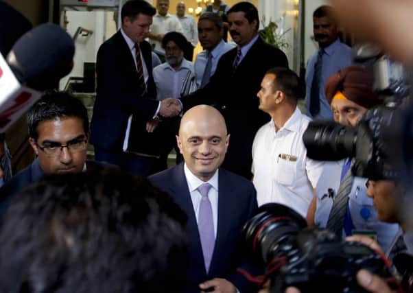 British Business Secretary Sajid Javid, center, returns after a meeting with Tata chairman Cyrus Mistry at the Bombay House, the Tata group's headquarters, in Mumbai, India, Wednesday, April 6, 2016. India's Tata Steel had earlier announced plans to sell its loss-making U.K. plants, which employ almost 20,000 people. The steel industry in Britain, as in many developed economies, has been hit hard by cheap Chinese imports, which have depressed prices. (AP Photo/Rajanish Kakade)