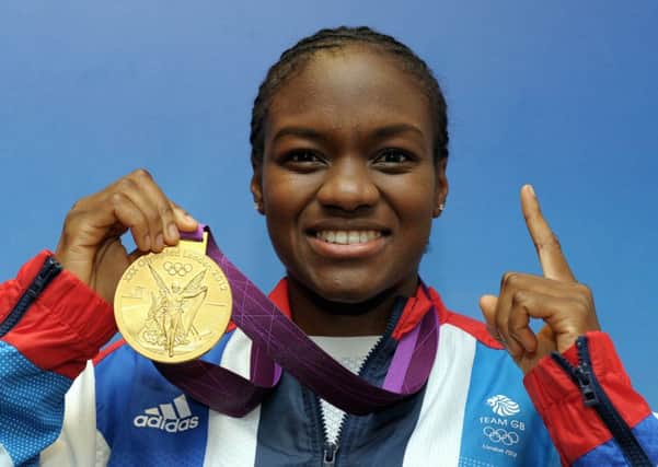 Leeds boxing star Nicola Adams with her London Olympics gold medal ( Picture: PA).