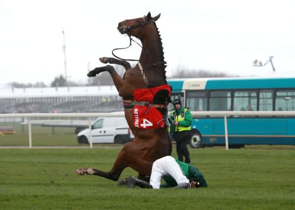 Footpad ridden by Ruby Walsh takes a fall in the Juvenile Hurdle on the opening day of the Crabbie's Grand National Festival at Aintree. Picture: David Davies/PA.