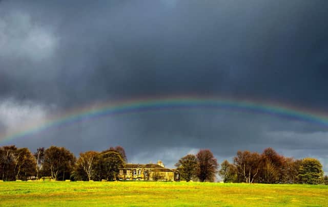 A rainbow cuts through storm clouds gathering over Heath Common near Wakefield. Picture: SWNS