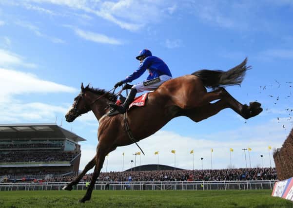 EASY RIDER: Cue Card and Paddy Brennan on their way to winning the Betfred Bowl Chase at Aintree . Picture: Mike Egerton/PA