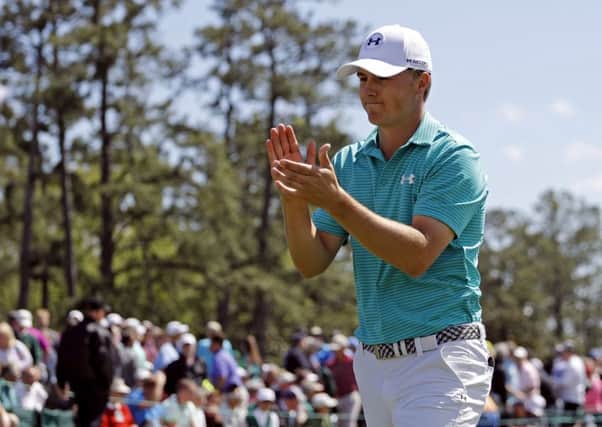 Jordan Spieth applauds the spectators on the 18th green following his first round of 66 at the 2016 Masters (Picture: Matt Slocum/AP).