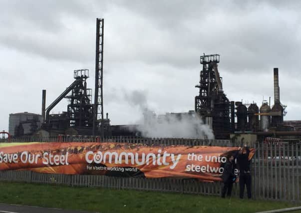 Members of Community Trade Union erect a banner outside the steelworks in Port Talbot, where Business Secretary Sajid Javid will make a second visit to meet managers and workers' representatives.
