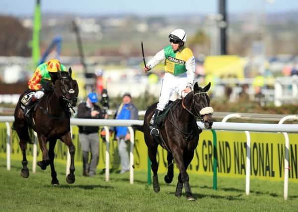 Jockey Leighton Aspell celebrates on board Many Clouds after victory in last year's Grand National (Picture: Mike Egerton/PA Wire).