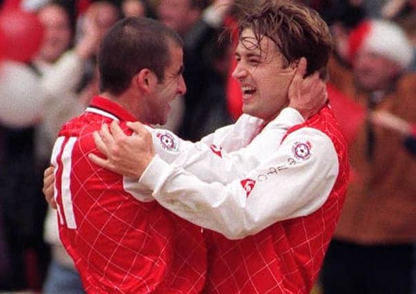 Rotherham United's Nigel Jemson, right, is congratulate  by team-mate Andy Roscoe after his second and winning goal in the Auto Windscreens Shield final against Shrewsbury Town in 1995 (Picture: Neil Munns/PA)