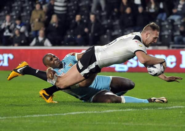 FLYING HIGH: Liam Watts, left,  celebrates another Hull FC try with team-mate Frank Pritchard in their victory over Huddersfield Giants at the KC Stadium on Friday evening. Inset, Watts dives in for a try. Pictures: Steve Riding