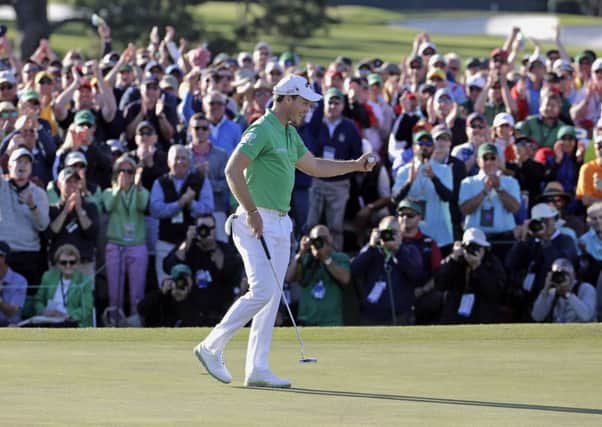 Danny Willett celebrates on the 18th hole after finishing the final round of the Masters (Picture: Charlie Riedel/AP).