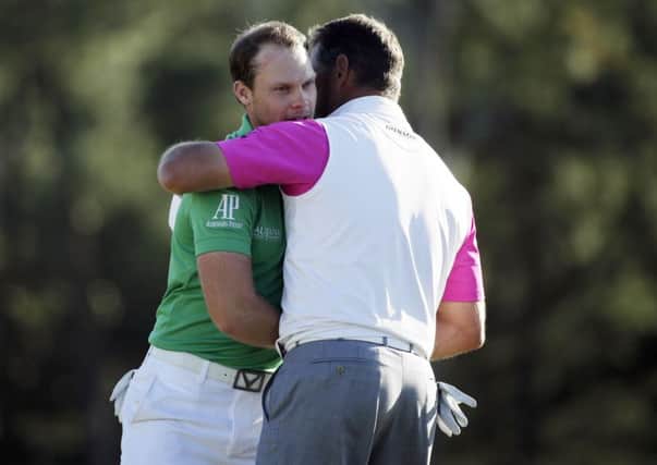 Danny Willett is congratulated by Lee Westwood after finishing the final round of the Masters (Picture: Chris Carlson/AP).
