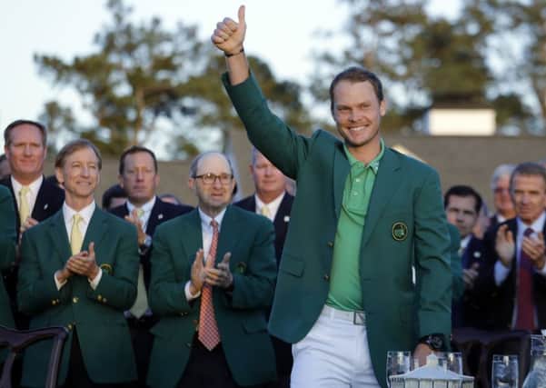 Yorkshireman Danny Willett acknowledges the applause as he dons the green jacket awarded to Masters champions. Willett triumphed by three shots at Augusta, his first major title (Picture: Jae C Hong/AP).