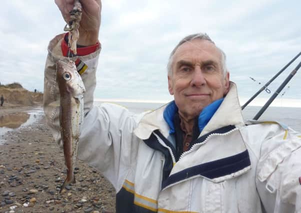 Stewart Calligan holding aloft a whiting he caught on his latest sea fishing expedition.
