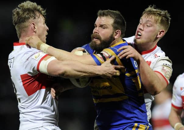 Adam Cuthbertson is held by Graeme Horne and James Greenwood of Hull KR.