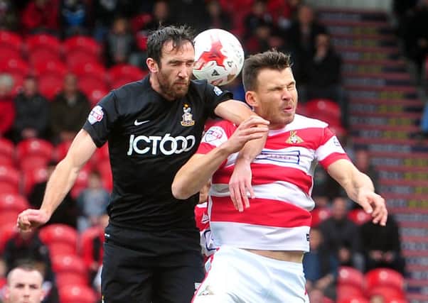 Bradford Citys Rory McArdle duels with Doncaster Rovers Andy Butler (Picture: Tony Johnson).