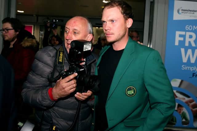 Danny Willett signs autographs as he arrives at Manchester Airport after his victory at The Masters in Augusta on Sunday.