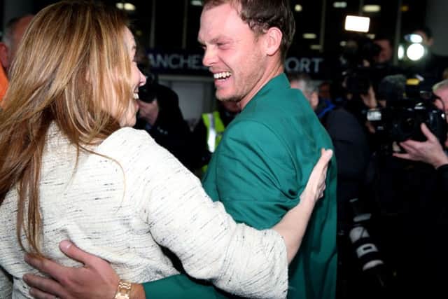 Danny Willett signs autographs as he arrives at Manchester Airport after his victory at The Masters in Augusta on Sunday.