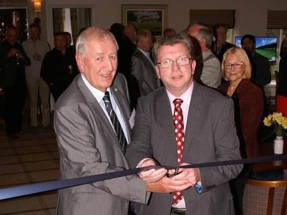 Shipley GC president Jimmy Greaves, left, helps former Sports Minister Gerry Sutcliffe cut the ribbon at the official launch of the refurbished clubhouse.